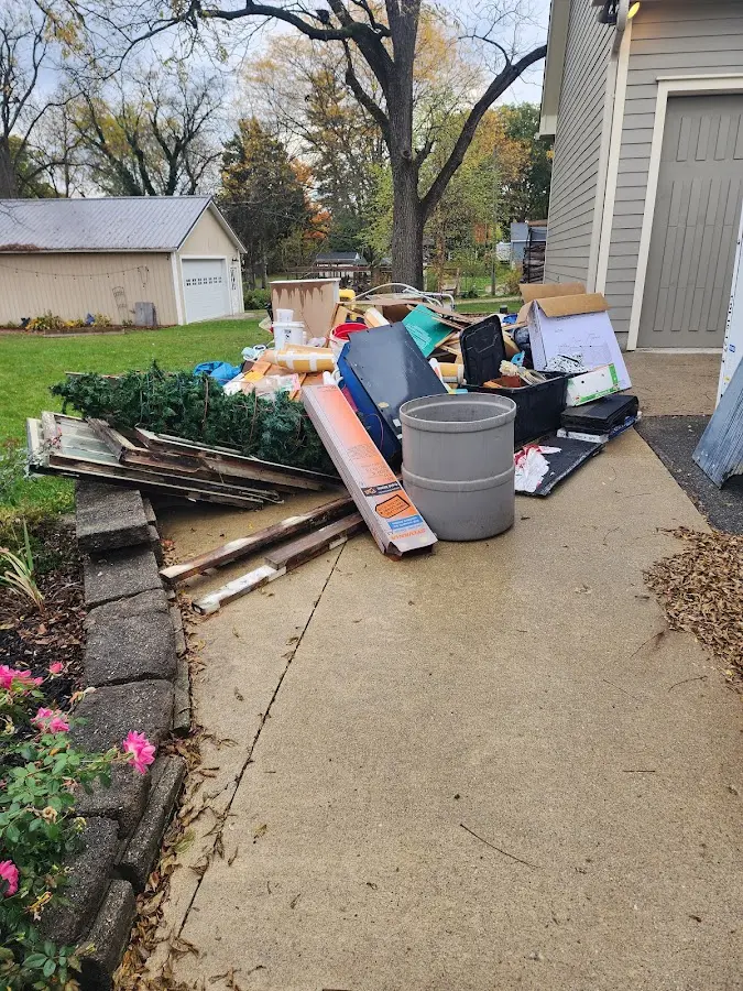 Dumpster being loaded with debris for Roofing Dumpster Rental in Woodhaven